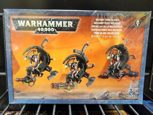 Warhammer 40,000 Necron Tomb Blades miniatures box set by Games Workshop, featuring three green and black mechanical blade units on an orange illustrated background.
